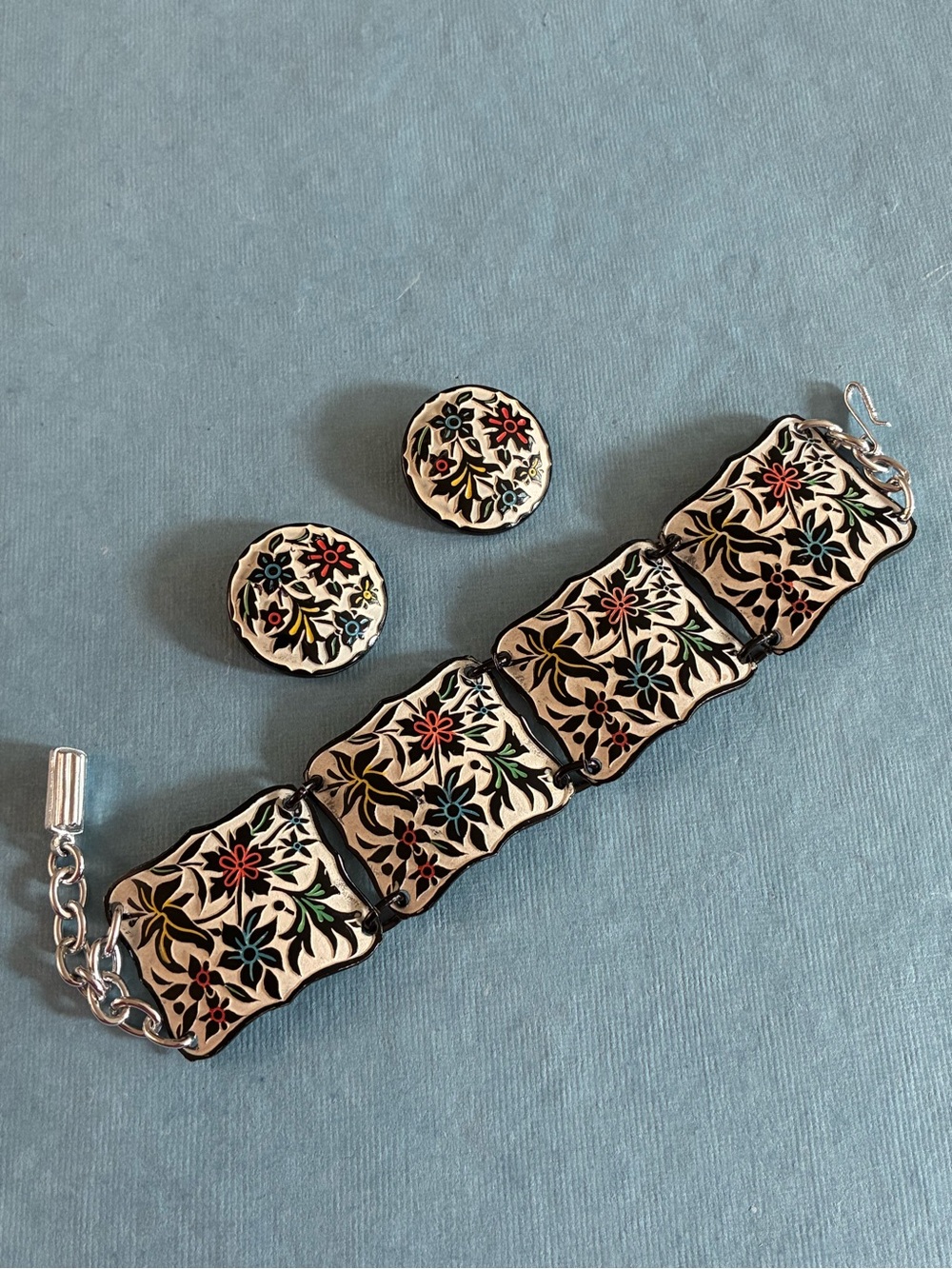 West Germany floral relief enameled bracelet and clip earrings set on beige